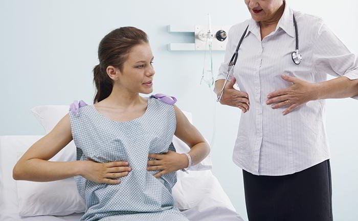 How can I self-examine my breasts?